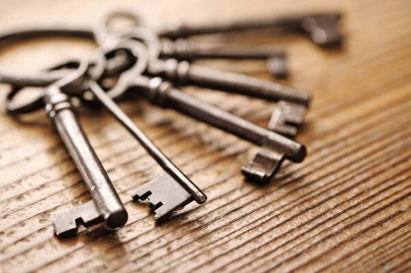 old keys on a wooden table, close up