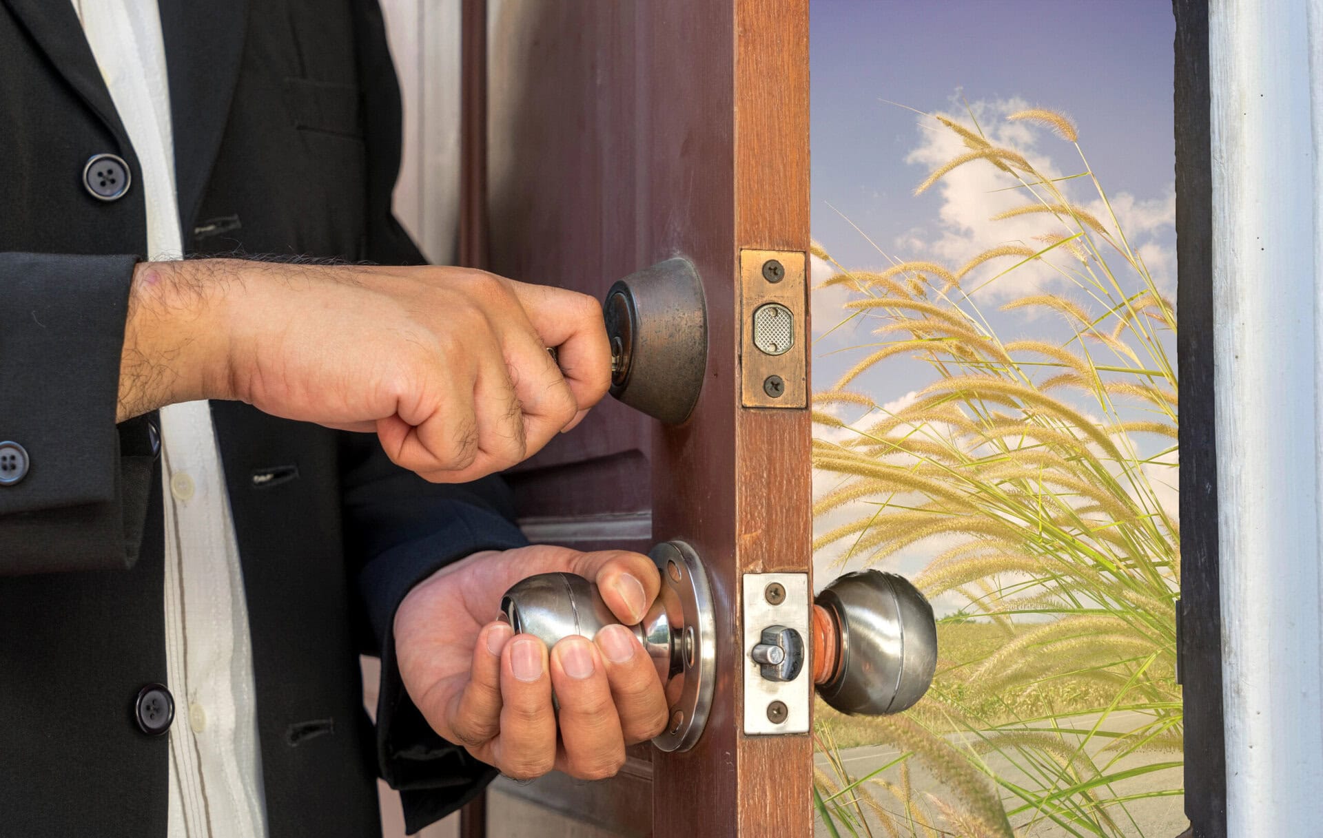 Businessman open the door by key to new road view and warm filter